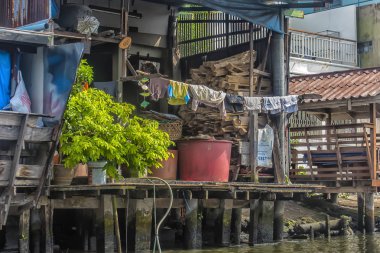 Riverside slums & Fishermen Life in Chao Phraya River clipart