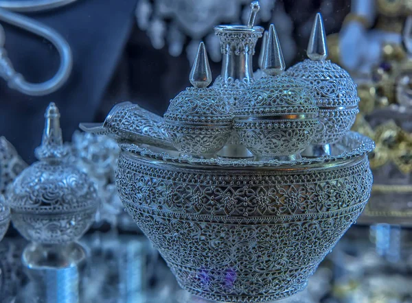 Silver jewelry and other silverware in a shop window — Stok fotoğraf