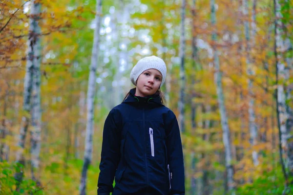 穿着黑色夹克和白色贝雷帽在秋天公园散步的女孩 — 图库照片