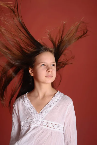 Niña Morena Estudio Sobre Fondo Rojo Con Pelo Volador — Foto de Stock