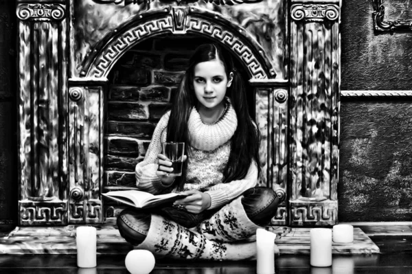 Fiatal Lány Egy Pulóverben Egy Könyvvel Gyertyákkal Kandalló Mellett — Stock Fotó