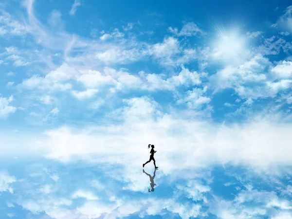 3D silhouette of a female jogging against a sky which is reflect — Stockfoto