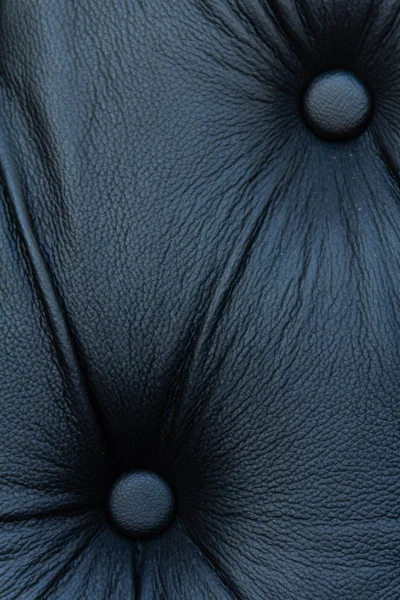 Black genuine leather sofa pattern — Stock Photo, Image