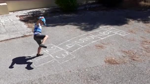 Young Boy Playing Hopscotch — Stock Video