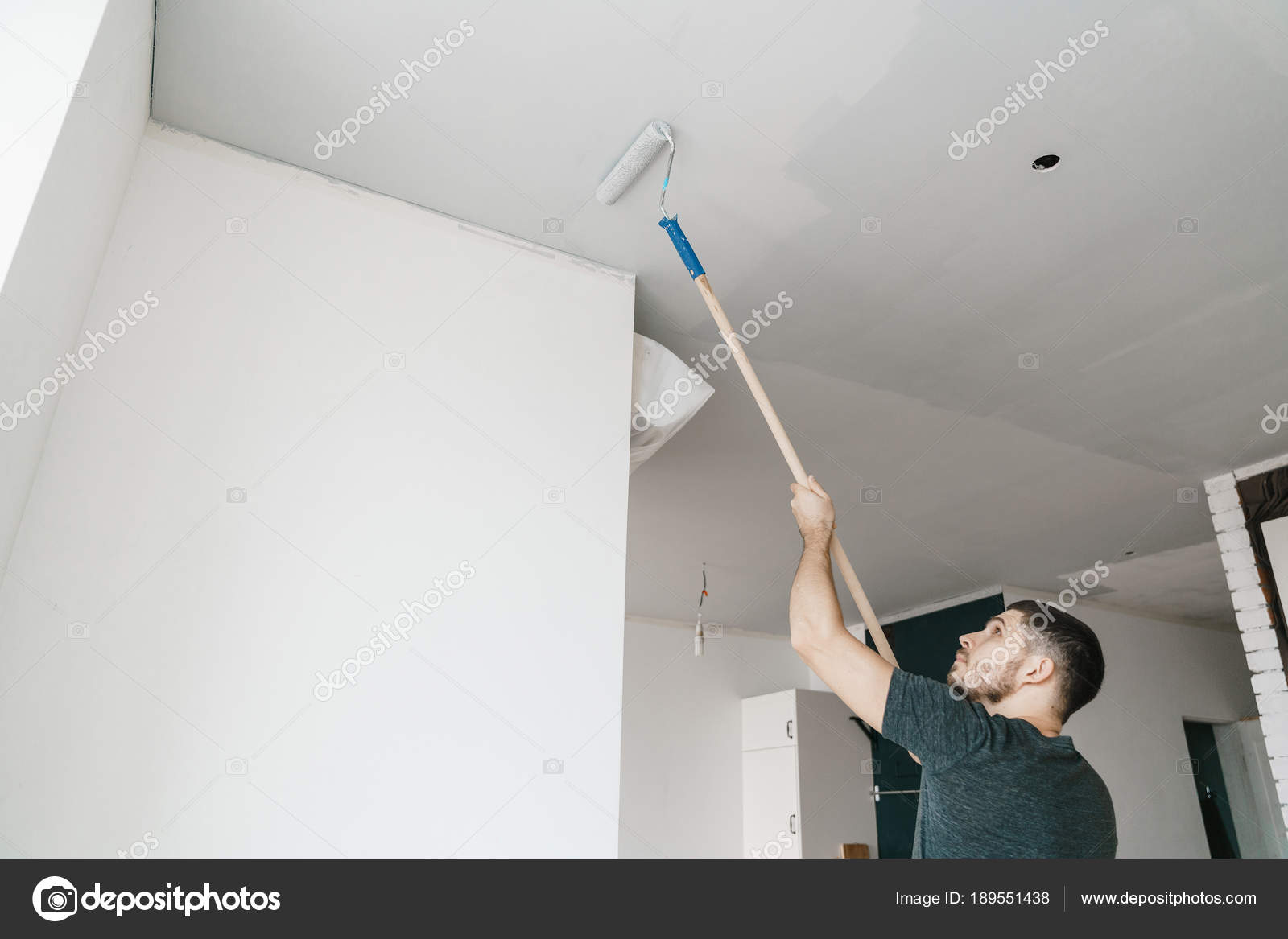Man Paints Ceiling Gray Color Roller Home Repair Renovation