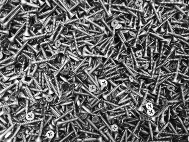 Many metal self-tapping screws. Steel self-tapping in bulk. clipart