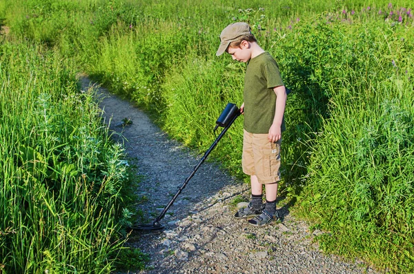 Serious boy with a metal detector — Stock Photo, Image