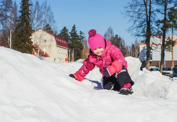 Vrolijk meisje op een wandeling een heldere winterdag. — Stockfoto