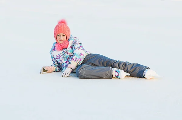 Skater girl is lies on the ice — стоковое фото