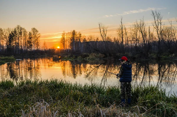 Woman fishing at sunset — Stock Photo, Image