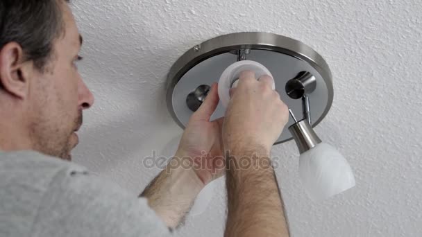 Man Changing Lightbulb on Ceiling Fixture Closeup — Stock Video