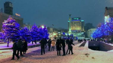 İnsanlar Noel süsleri önünde Maidan bağımsızlık Meydanı'nda yürürken, insanlar