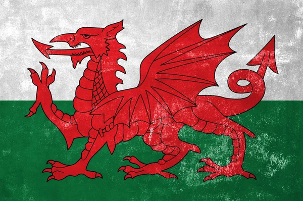 Wales - walisisk flag på Old Grunge Texture Baggrund - Stock-foto