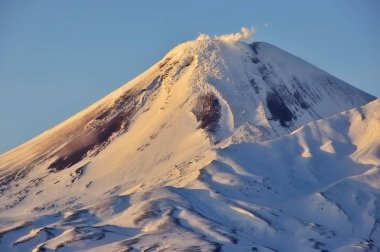 Aerial image of snow-covered Russian Volcano clipart