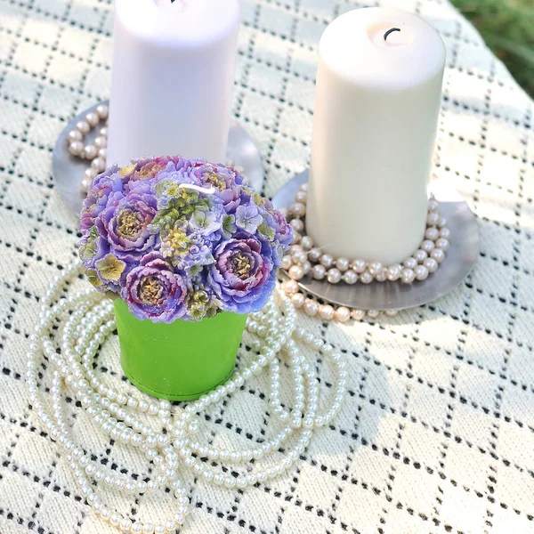 Flowers in a vase and candles — Stock Photo, Image