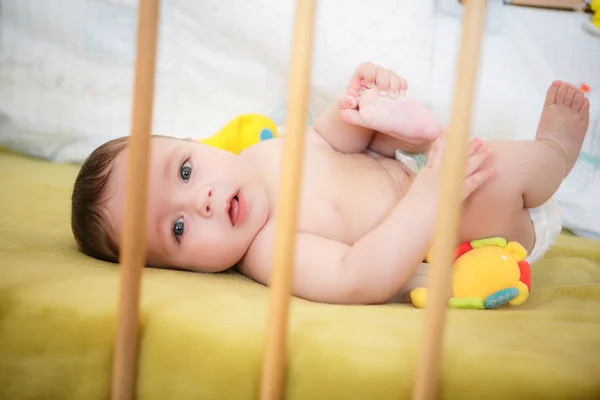 Portrait of  newborn boy is lying  in the bed — Stock Photo, Image