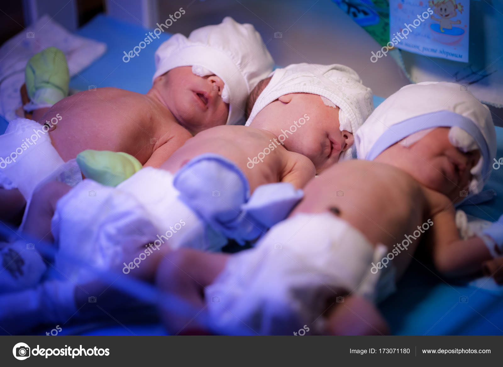 Newborn triplets baby are under the device with ultraviolet