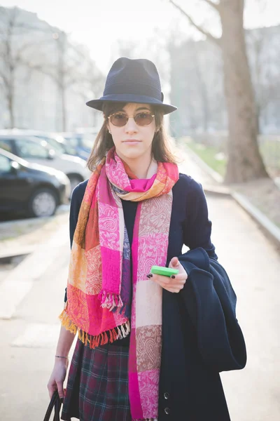 Woman walking in town using smartphone — Stockfoto
