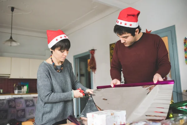 Coppia avvolgendo regalo di Natale — Foto Stock