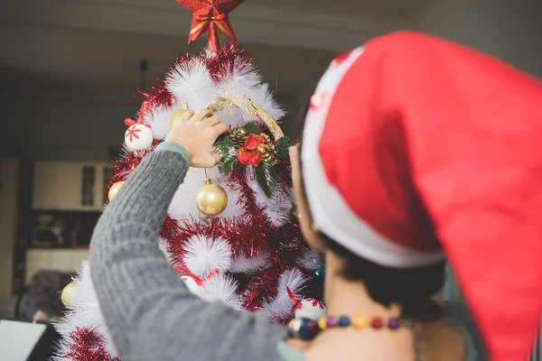 Frau schmückt Weihnachtsbaum — Stockfoto