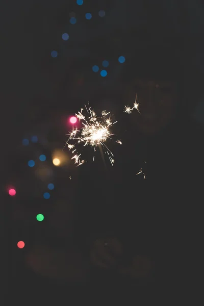Woman celebrating holding a sparkler — Stock Photo, Image