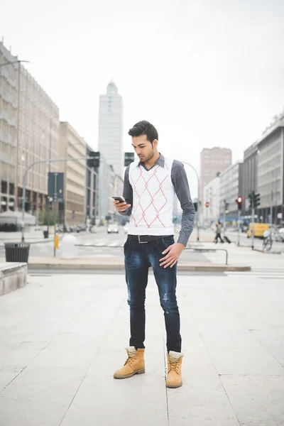 Uomo d'affari a piedi attraverso la città utilizzando smartphone — Foto Stock