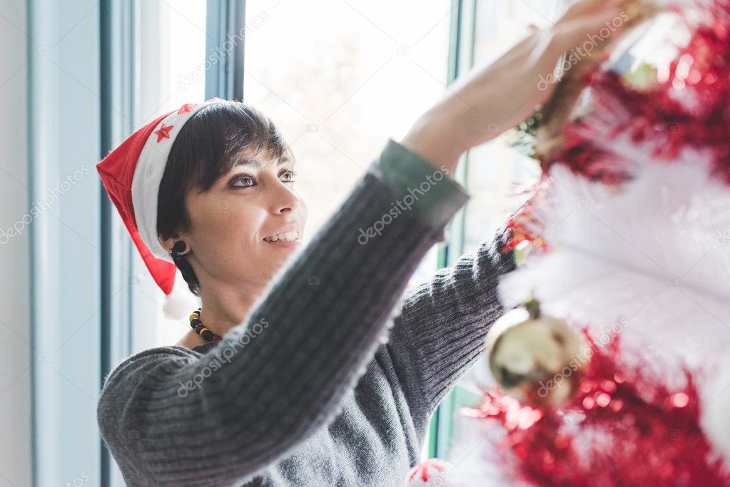 woman decorating christmas tree