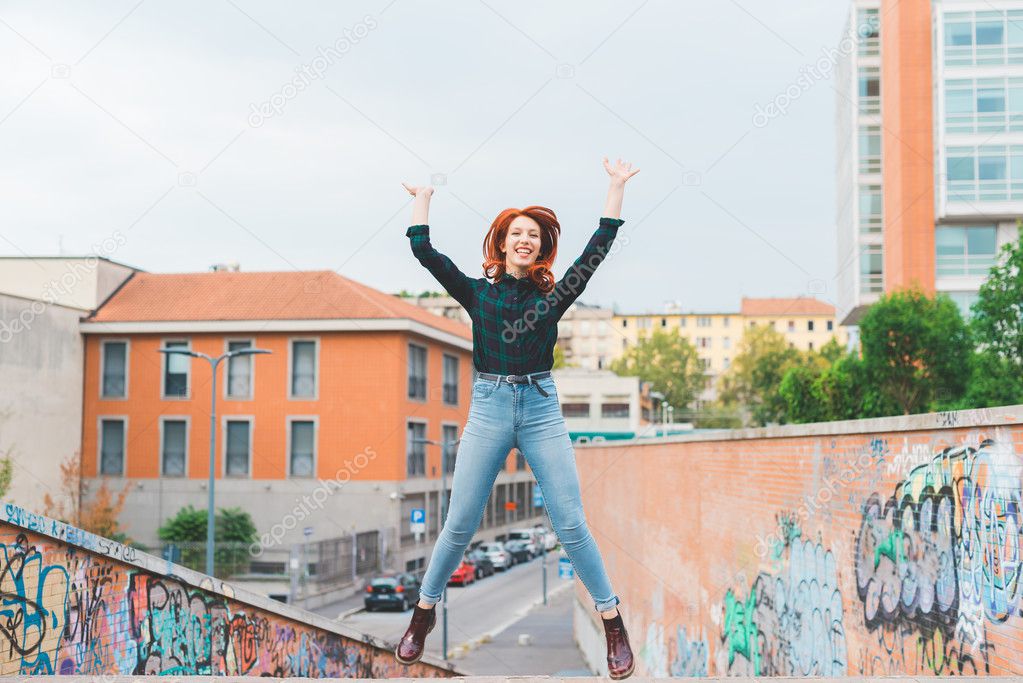 woman jumping outdoor in city