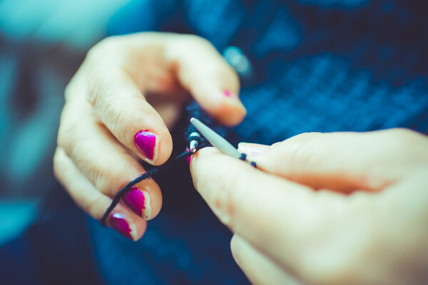 woman's hands knitting