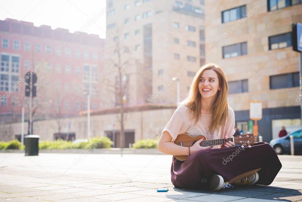 woman playing ukulele 