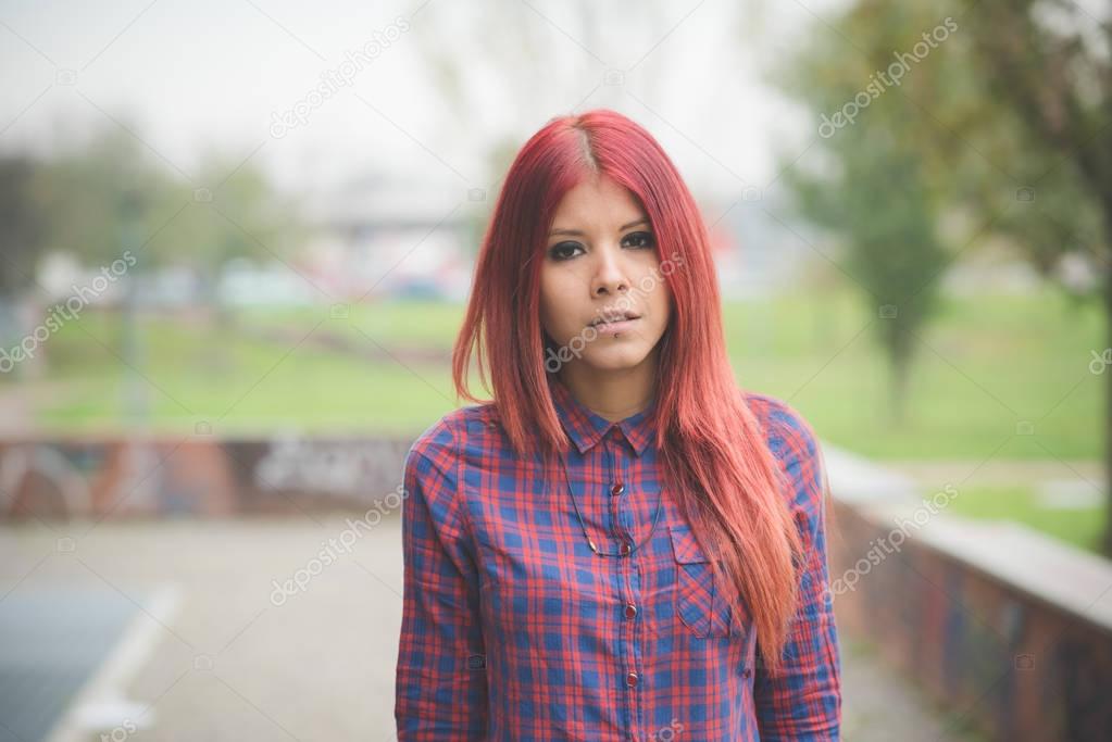 red hair woman outdoor looking at camera