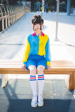 woman sitting on wooden bench clipart