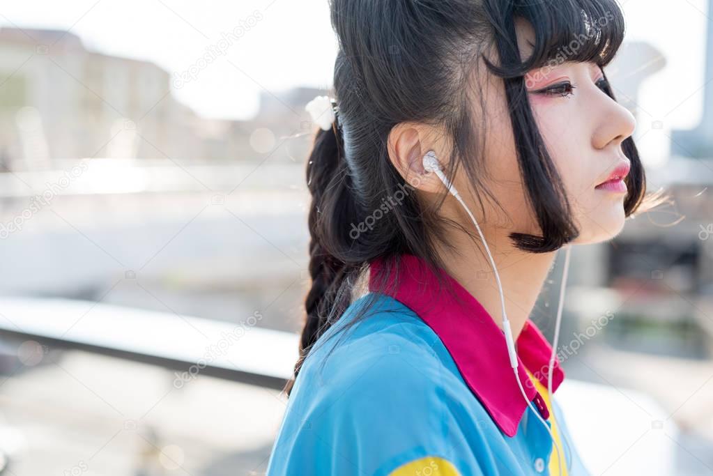 woman listening music with earphones