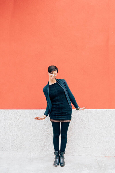 woman against orange and white wall