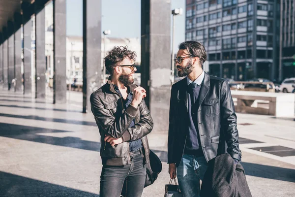 Business men walking in city talking — стоковое фото