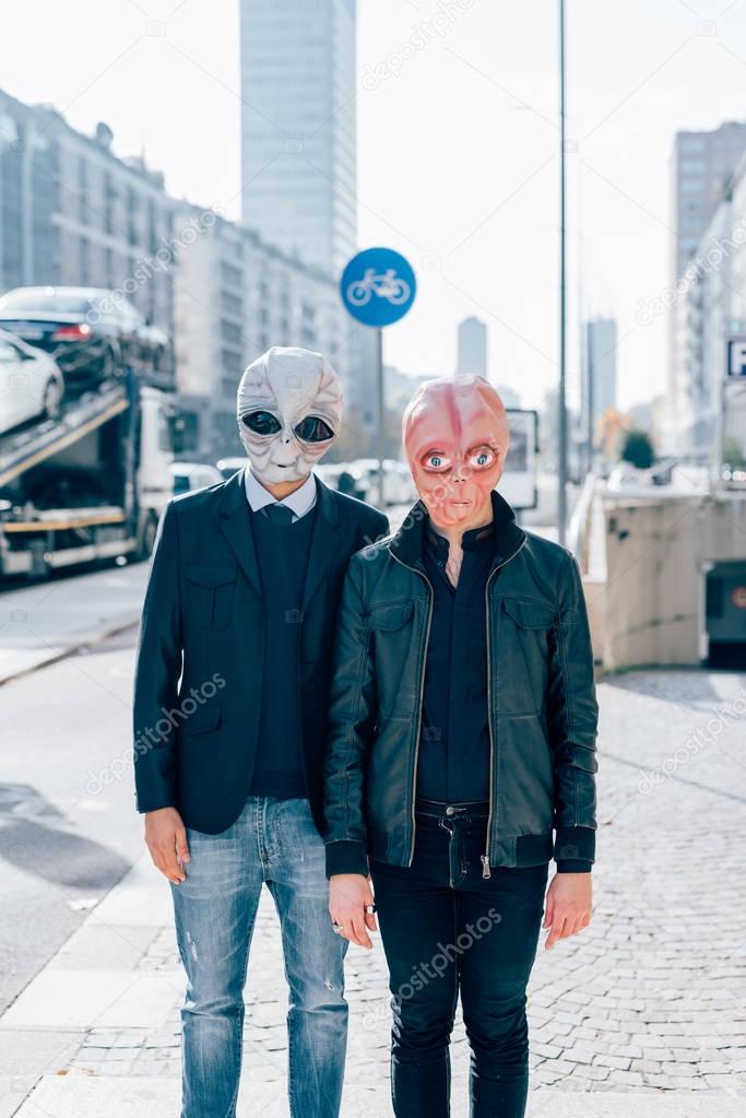 men wearing alien masks