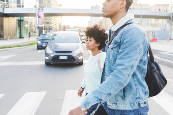 multiethnic couple walking in city
