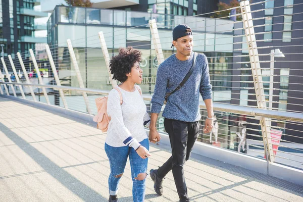 multiethnic couple walking in city