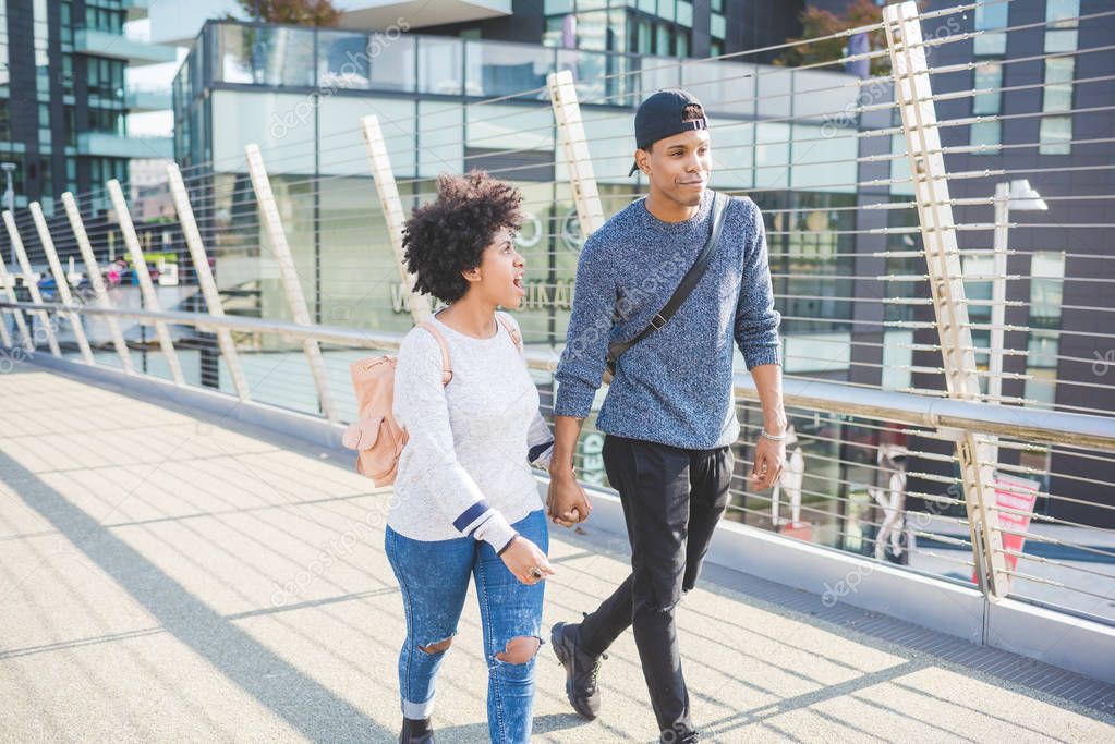 multiethnic couple walking in city 