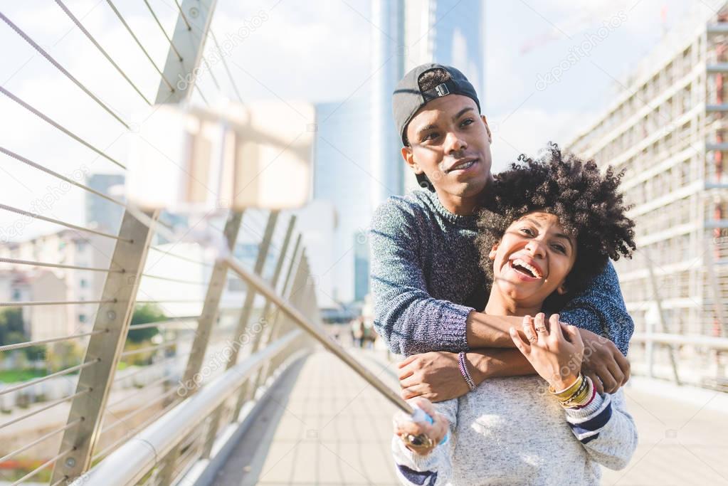 multiethnic couple taking selfie 