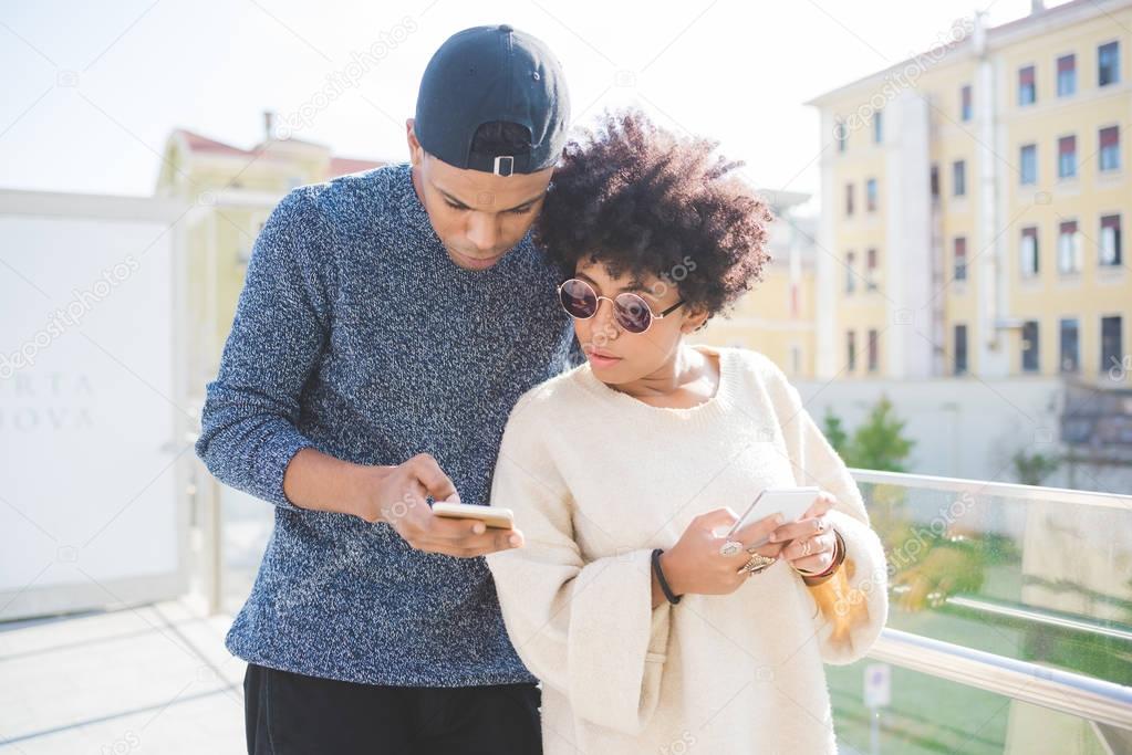multiethnic couple using smartphone 