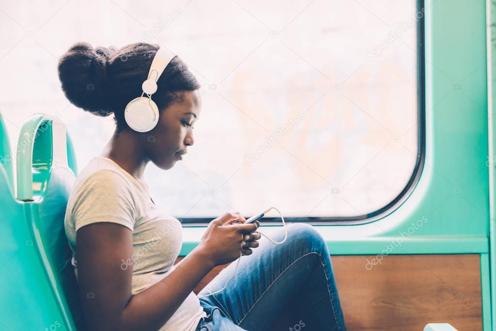 woman listening music travelling by bus