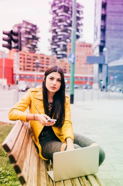 defter ve akıllı telefon kullanan kadın