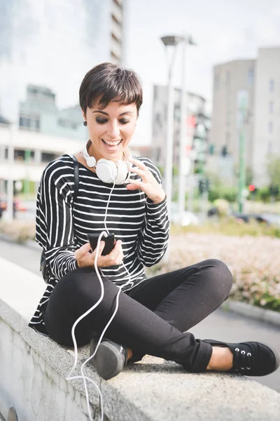 Woman with smartphone and headphones — Stock Photo, Image