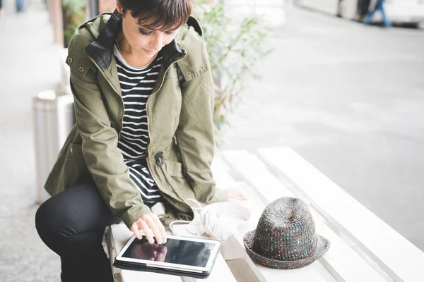 Woman sitting outdoor in city using tablet — Stock Photo, Image