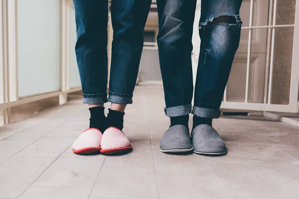 man and woman wearing slippers indoor