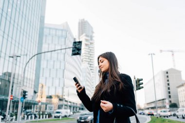 İş kadını akıllı telefon kullanıyor.