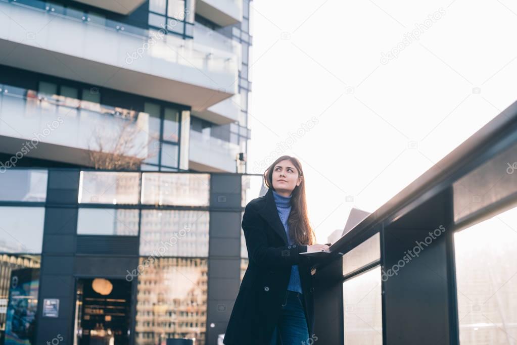 woman outdoor in city using computer