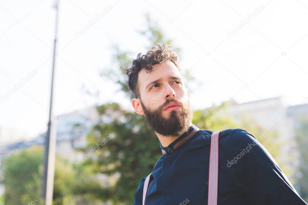 bearded man looking over pensive
