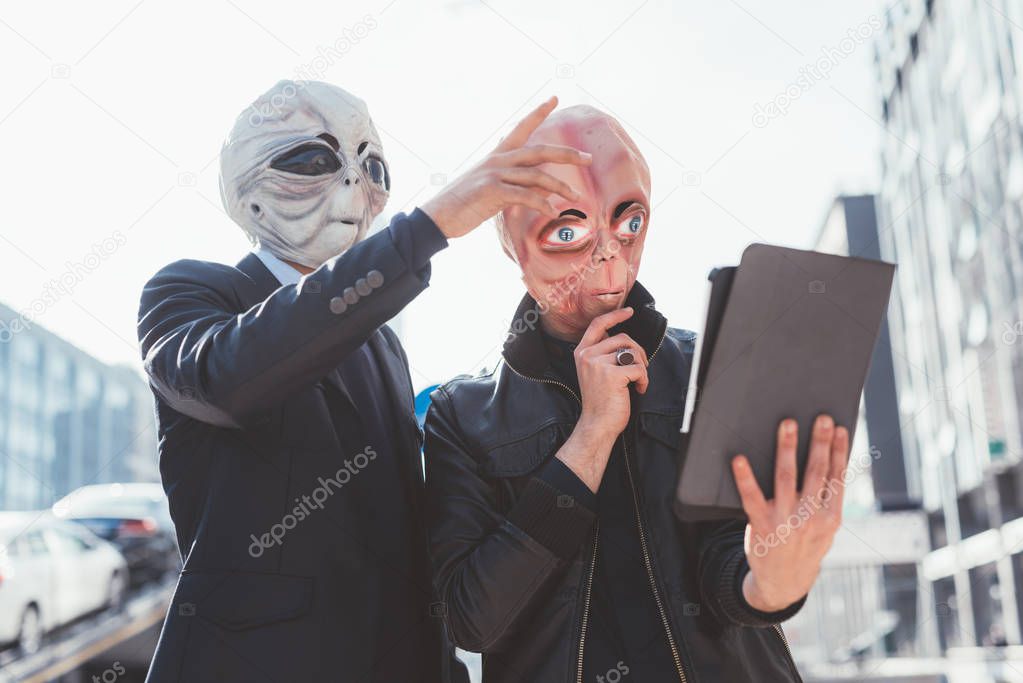 men wearing alien masks